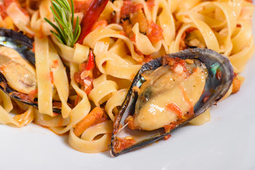 Homemade pasta with mussels, sprinkle with chopped parsley and basil. Delicious of pasta with mussel