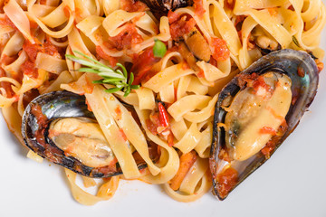 Homemade pasta with mussels, sprinkle with chopped parsley and basil. Delicious of pasta with mussel