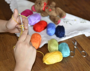 Hobby. Crochet things. The child learns to knit, thread, crochet hooks, scissors.