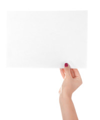 Obraz premium Female hand with empty sheet of paper on white background