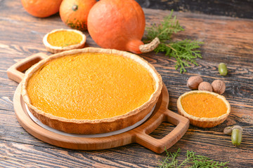 Tasty pumpkin pies on wooden table © Pixel-Shot