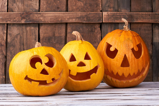 Three carved pumpkins for Halloween. Funny and angry pumpkins for Halloween. Seasonal Halloween decorations.