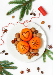 Decorating oranges with cloves for the new year or holiday. Top view.