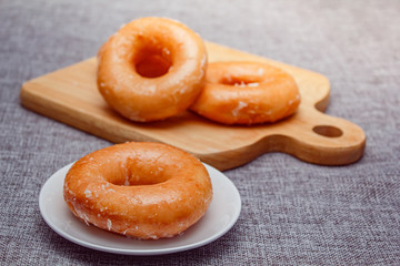 Donut toppint with sugar on a white color plate .