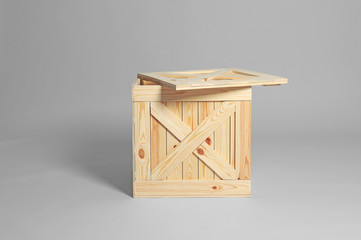 One open wooden crate on grey background