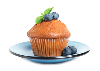 Plate with tasty muffin and blueberries on white background
