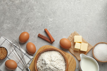 Flat lay composition with fresh ingredients for delicious homemade cake on light grey marble table. Space for text