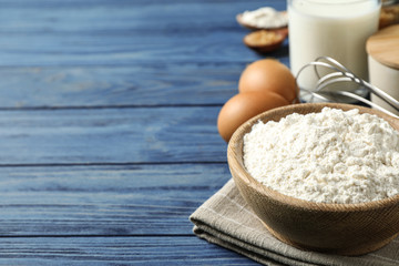 Fresh ingredients for delicious homemade cake on blue wooden table. Space for text
