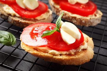 Tasty fresh tomato bruschettas on cooling rack