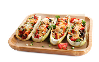 Wooden tray with delicious stuffed zucchini on white background