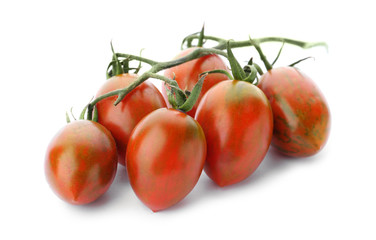 Branch of red grape tomatoes on white background
