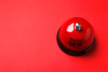 Sex bell on red background, above view. Space for text