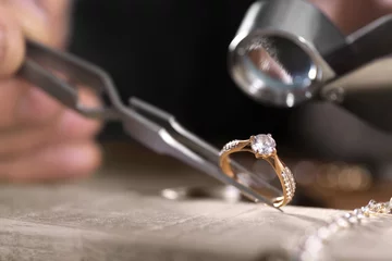 Foto op Plexiglas Male jeweler examining diamond ring in workshop, closeup view © New Africa