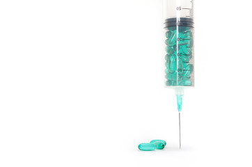 Syringe with pills on a white background. Health care in hospital. Colorful pills isolated on white background.
