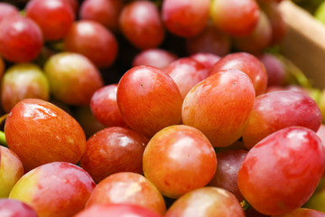 Fresh ripe juicy red grapes as background, closeup view