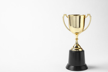 Shiny golden trophy cup on white background