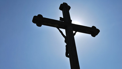 Crucifix, Jesus Christ cross against the blue sky.