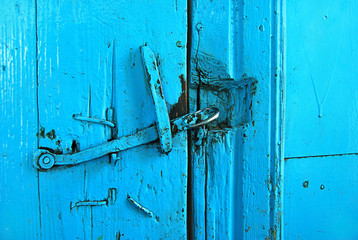 Old rustic wooden door. Rustic castle on the blue door.
