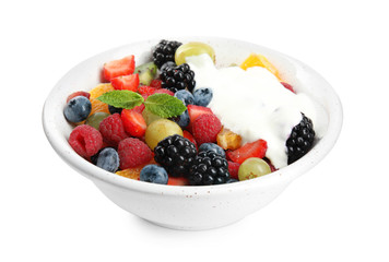 Fresh tasty fruit salad with yogurt on white background
