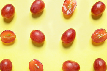 Naklejka na ściany i meble Flat lay composition with fresh ripe juicy grapes on yellow background