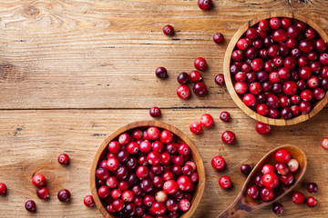 cranberries in a bowl on wooden table
