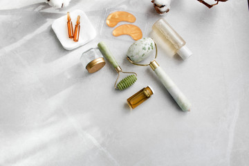 Dermaroller Natural stone, serum next to an anti aging face cream Beauty industry Close-up...