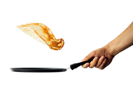 Frying pan with flying pancake isolated on white background