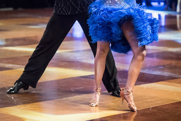 Legs of young dancers on the dance floor