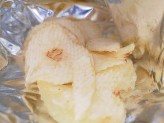 Close up heap of potato crisps on white background