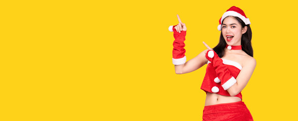 Portrait of an Asian woman wearing a Santa Claus cosplay costume. Standing happily at Christmas and happy New Year. With shoppers shopping as gifts. isolated on colorful yellow banner background.