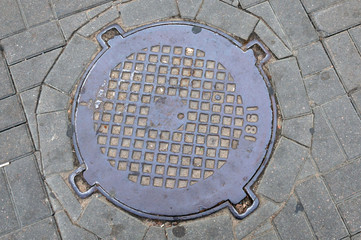 Sewer manholes to drain rainwater on the road.