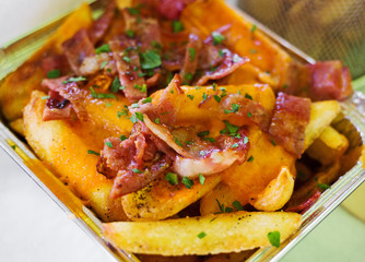Fast food. French fries with bacon.