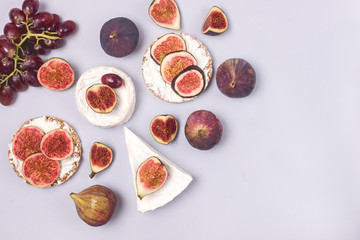 Brie Cheese Ripe Cut Figs Ripe Grape are Lying on Blue Background Food Background with Cheese and Autumn Fruits Copy Hardtack with Cheese and Figs Space Horizontal Copy Space