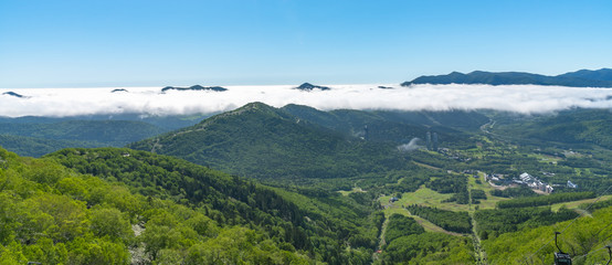 Panorama view from Unkai Terrace in summer time sunny day. Take the cable car at Tomamu Hoshino Resorts, going up to see the sea of clouds. Shimukappu village, Hokkaido, Japan
