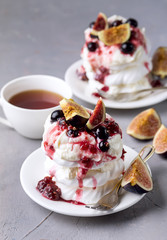 Mini Pavlova Cake with Figs and Berry Tasty Dessert Pavlova on White Plate Gray Background Cup of Tea Verttical