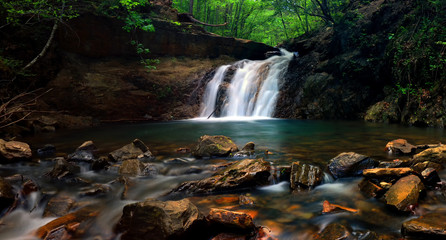 Creek flowing waterfall thru gorge and rocks
