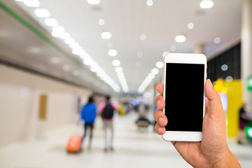 Hand hold black smartphone on blur shopping mall background