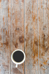 Top view hot black coffee on grunge wood table