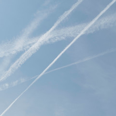 Five condensation trails in the air. Rising Transportation as problem for climate change.