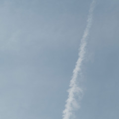 One white colored trace of an aircraft in the sky.