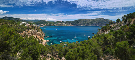 Fototapeta na wymiar Panorama of bay with luxury yachts rocky mountains of Cala Blanca Andratx, Mallorca, Spain