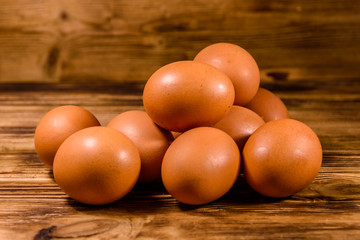 Pile of the hen eggs on wooden table