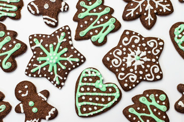 Gingerbread cookies on white background. Snowflake, star, man, heart shapes.