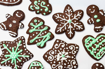 Gingerbread cookies on white background. Snowflake, star, man, heart shapes.