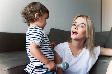 the babysitter plays with the baby and teaches him music