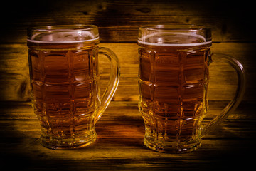 Two glasses of beer on wooden table