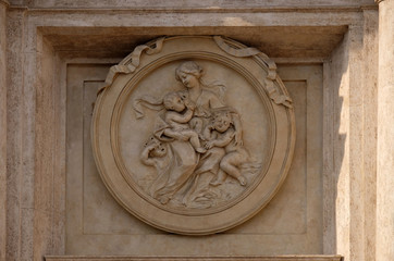 Charity Medallion on the Palazzo Montecitorio, seat of the Italian Chamber of Deputies in Rome,...
