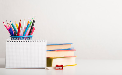 Fototapeta premium School and office supplies with books on white background