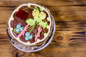 Kiev cake with cream, nuts and meringue in cardboard box on a wooden table. Top view