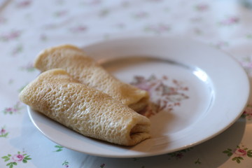 Pancakes rolled into a roll  lie on a plate